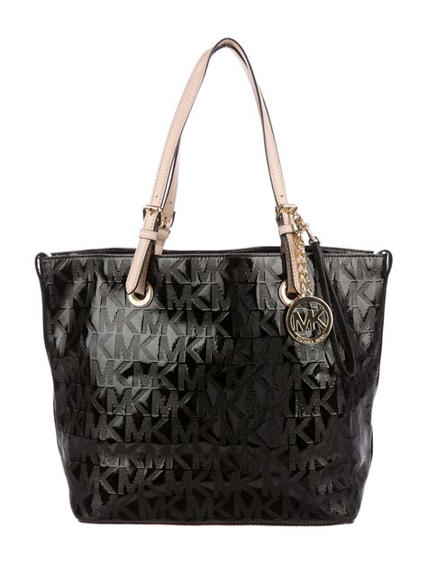 do all michael kors bags have feet|Michael Kors patent leather bag.